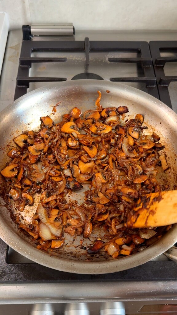 Caramelize the mushrooms and onions
In the same pan, cook sliced onions and mushrooms in vegan butter and olive oil until deeply browned.