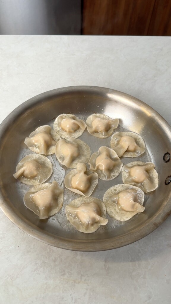 Pan fry and steamAdd oil and cook for 2 to 3 minutes until the bottoms are golden and crispy. Pour in water, cover with a lid, and steam for 5 to 6 minutes until the wrappers are translucent and cooked through.