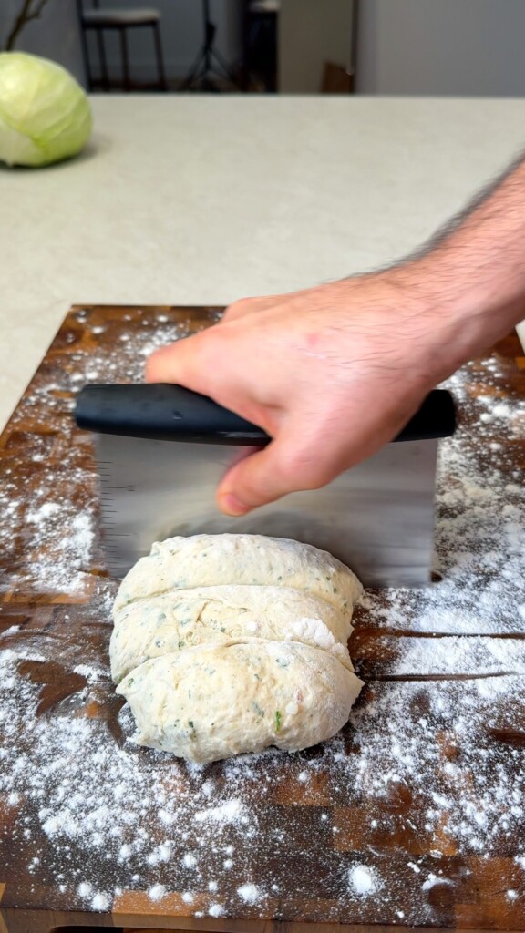 Divide Turn the dough onto a floured surface and divide into equal pieces with a bench scraper or knife.