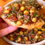 Lebanese balela salad with chickpeas, walnuts, and pomegranate molasses on crispy pita