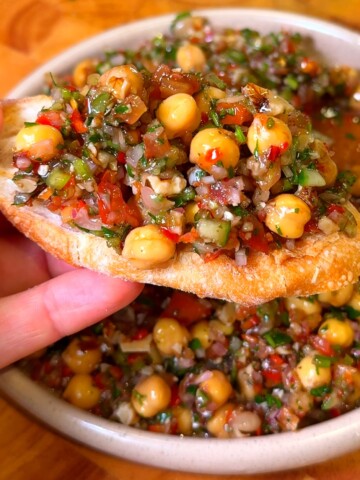 Lebanese balela salad with chickpeas, walnuts, and pomegranate molasses on crispy pita