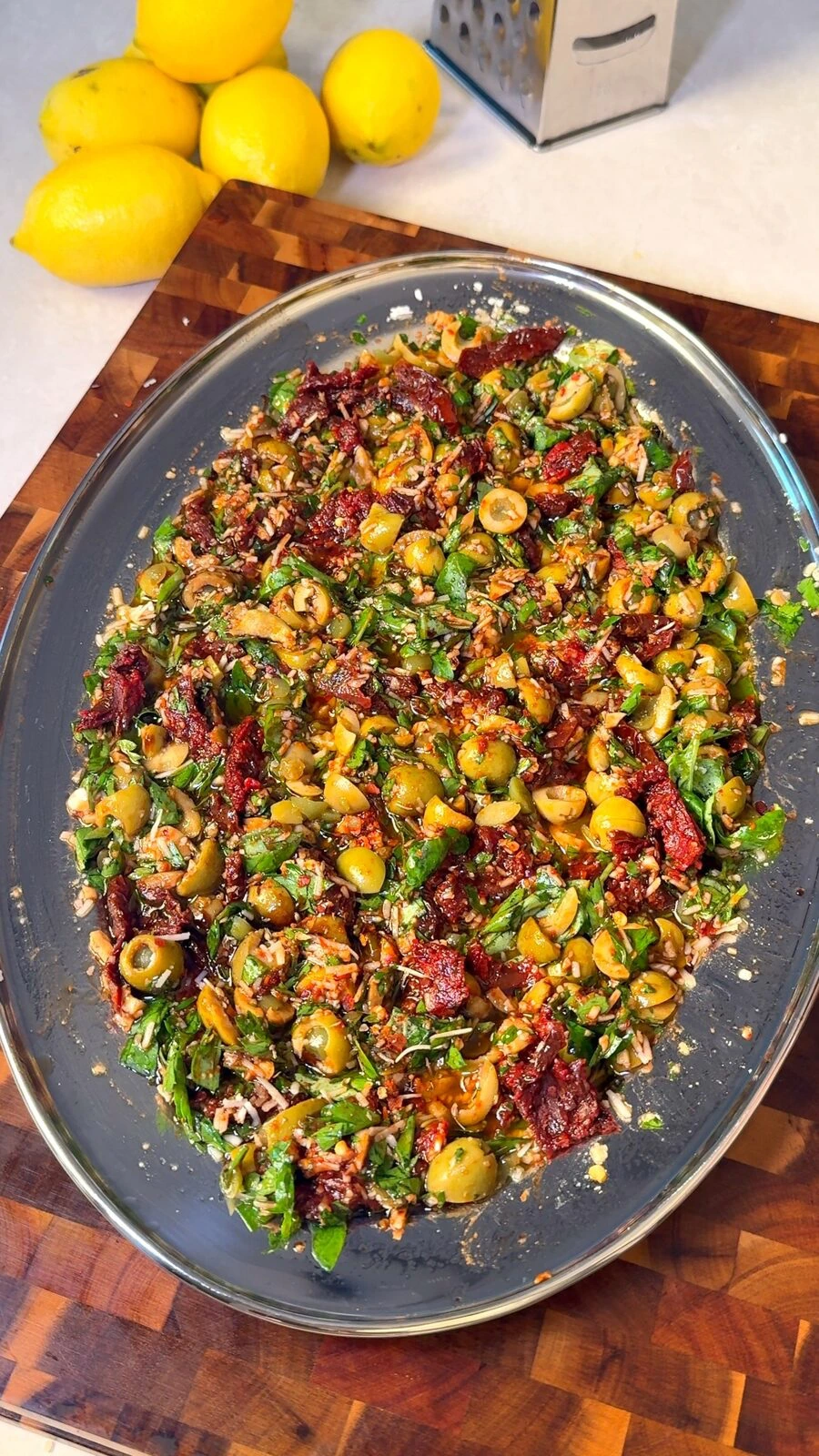 Olive bruschetta with sun-dried tomatoes and herbs on a platter