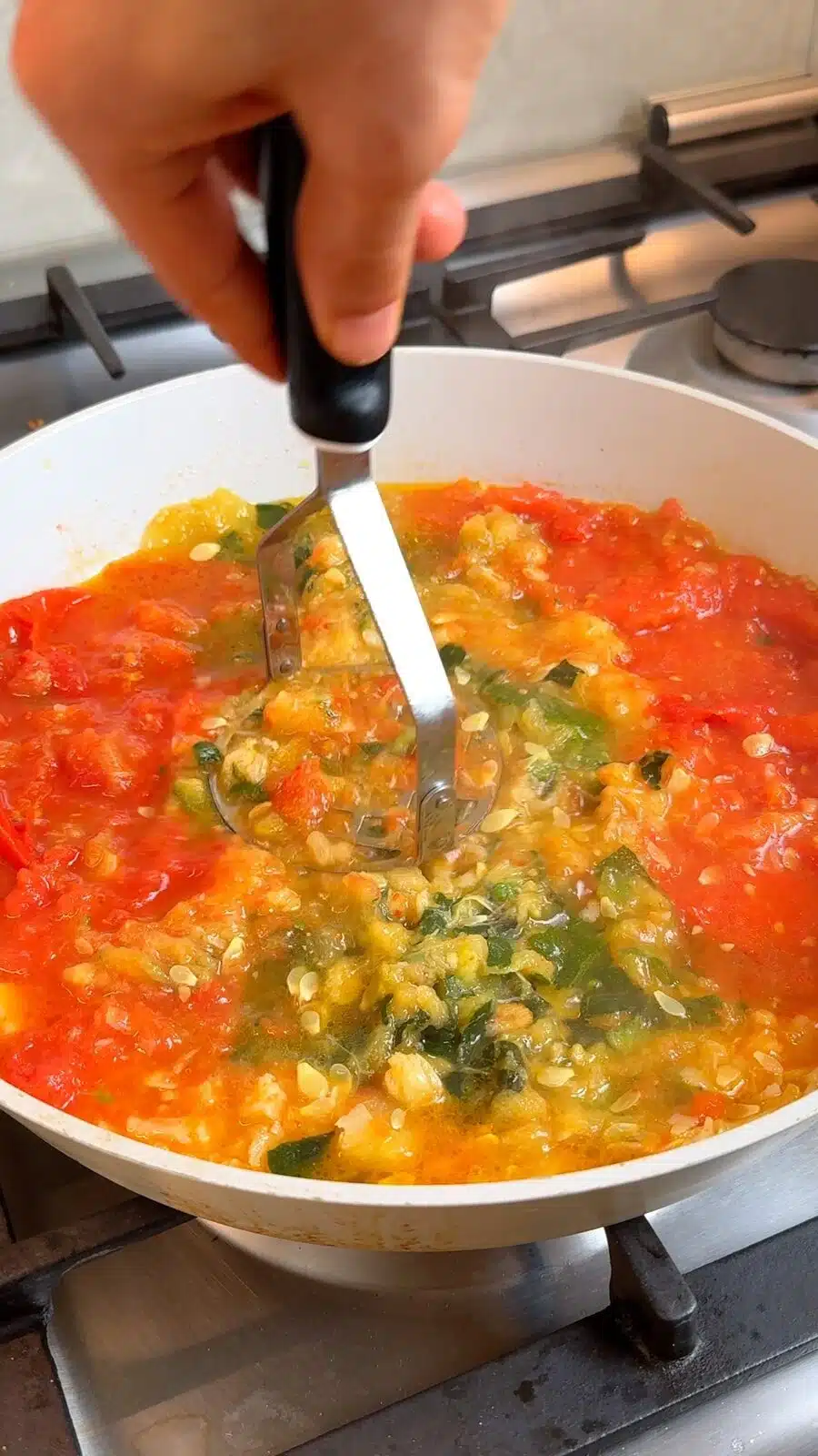 Softened zucchini and tomatoes mashed into a chunky sauce