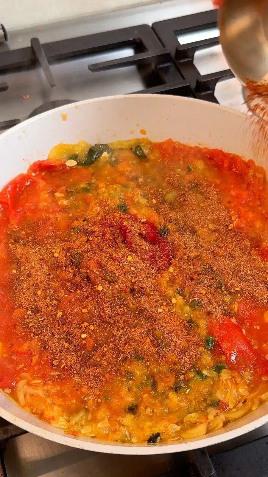 Tomato paste and seasoning stirred into the sauce