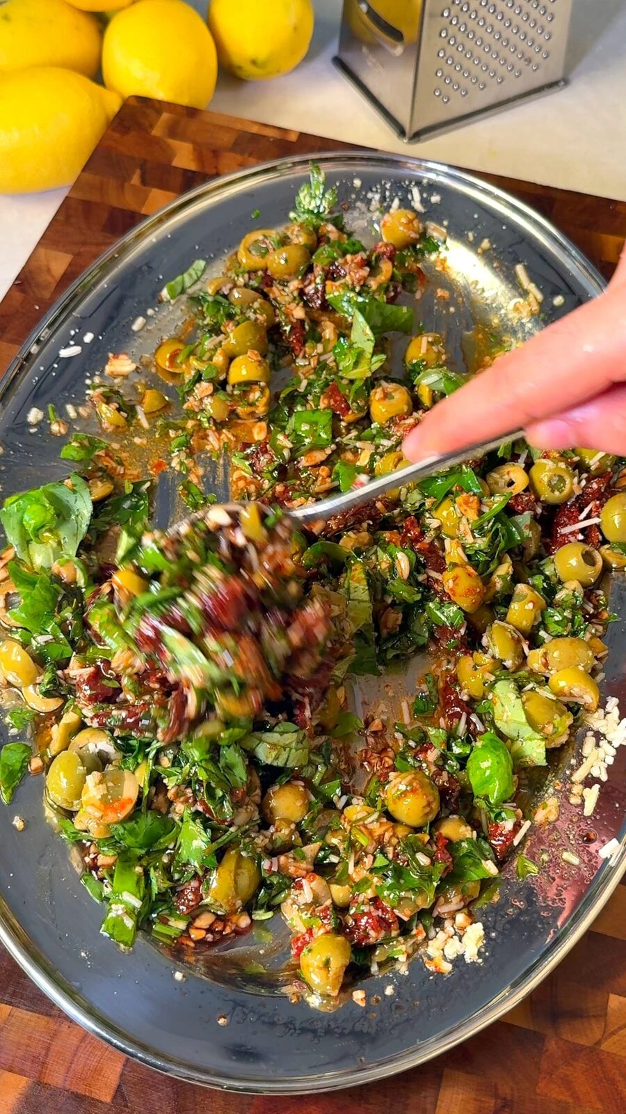 Tossing the olive bruschetta topping together