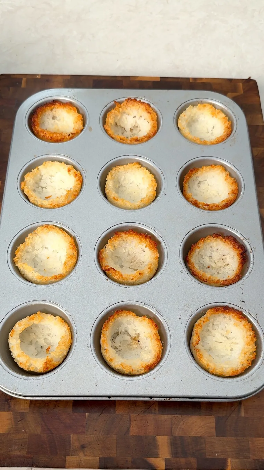 Twelve golden baked crispy rice cups in a muffin tin