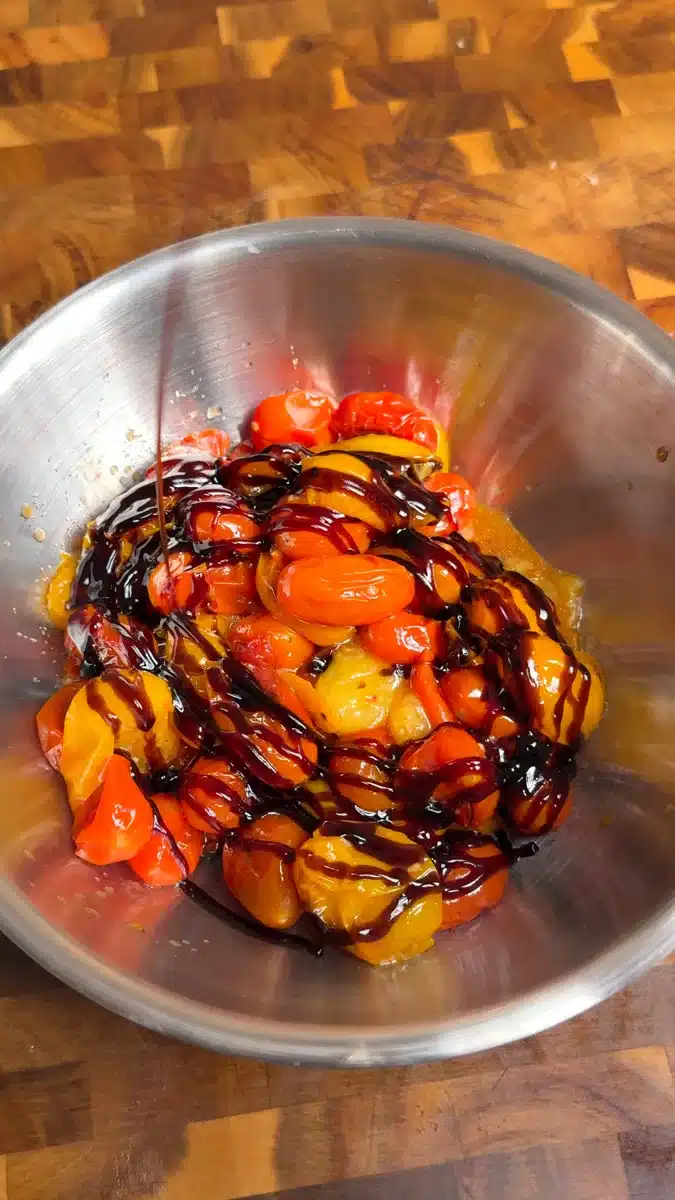 Balsamic glaze drizzled over roasted red and yellow cherry tomatoes