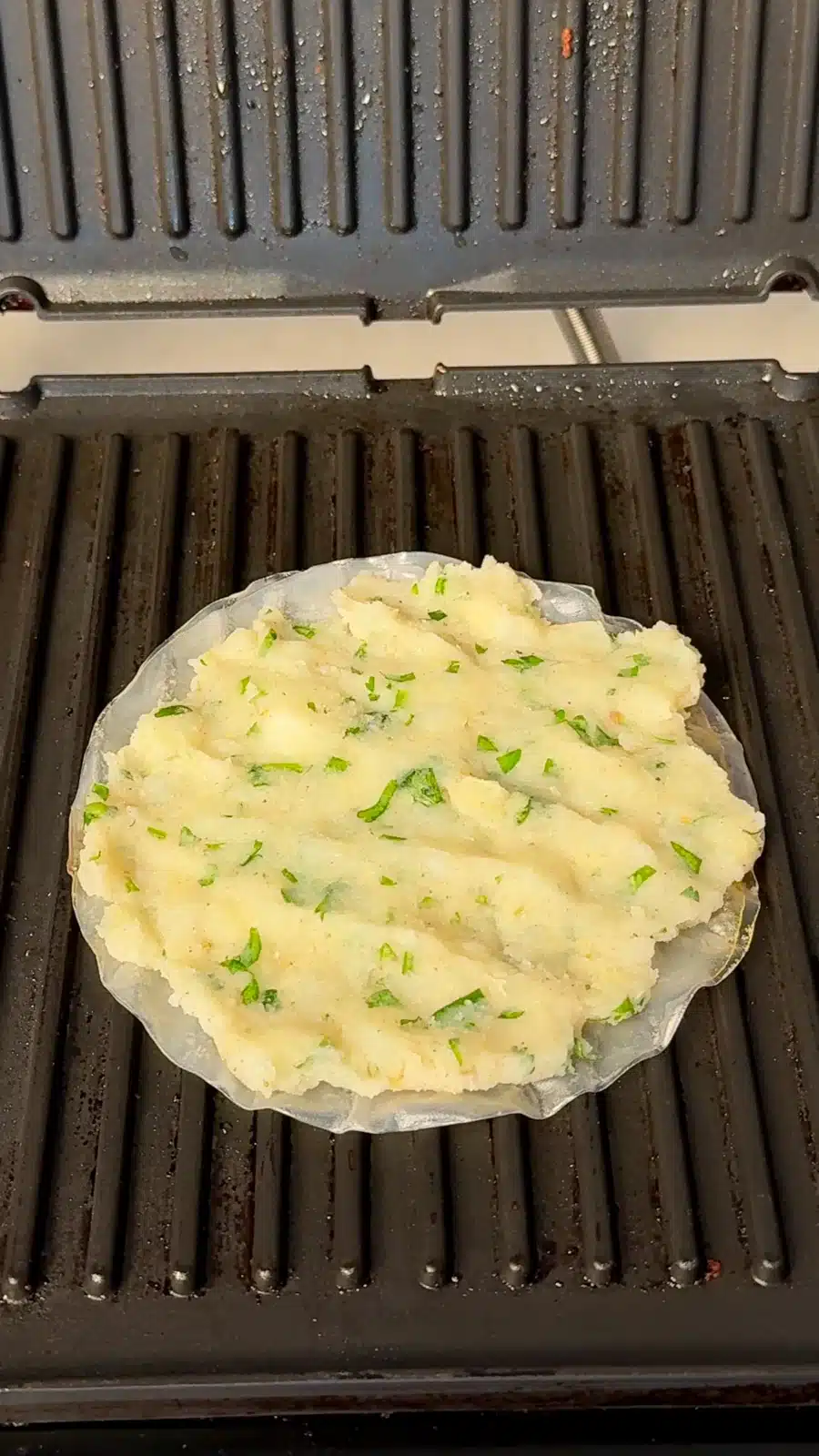 Mashed potato with chopped herbs spread over rice paper