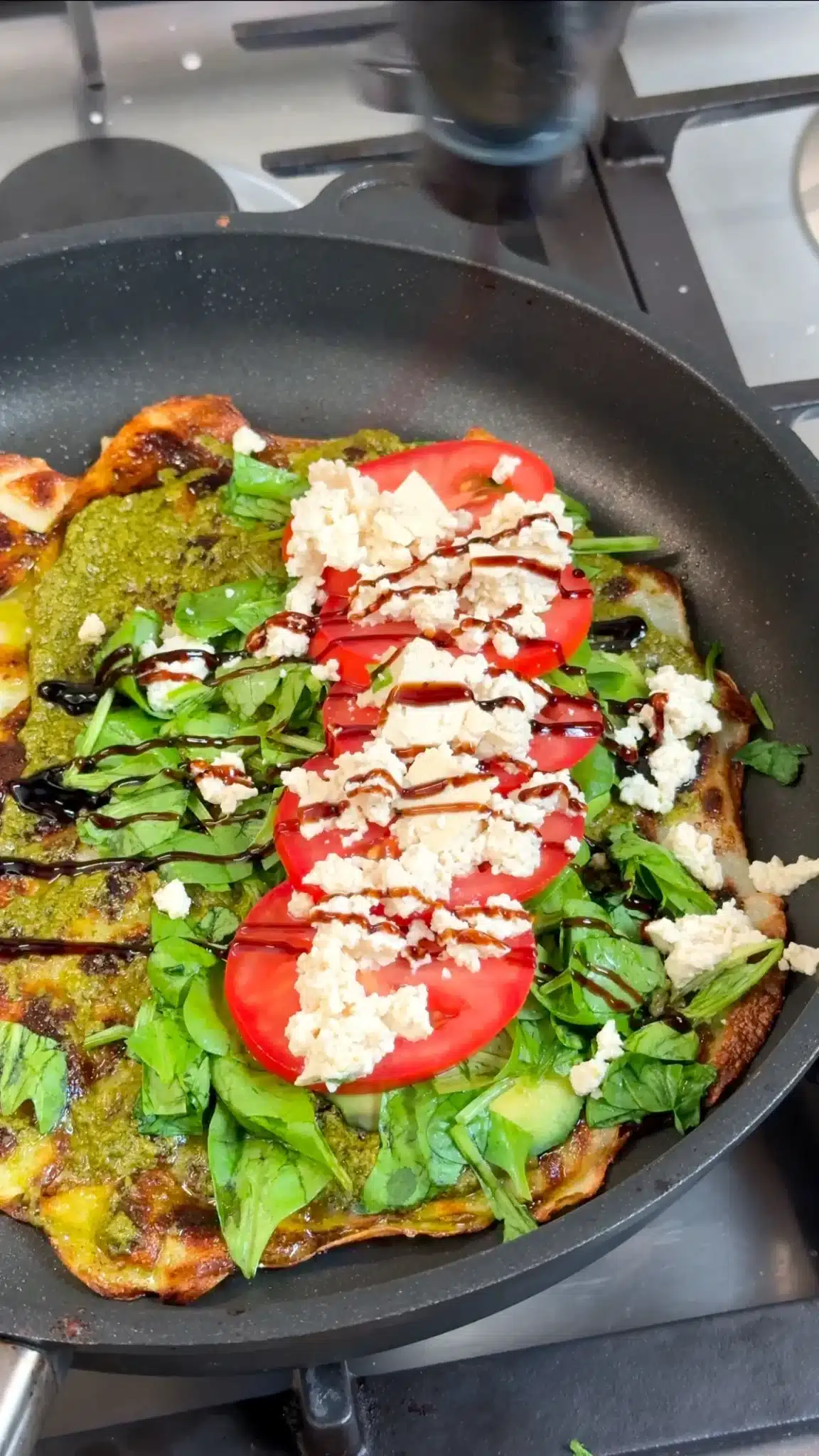 Potato base topped with pesto, avocado, greens, tomato, crumbled tofu and balsamic glaze