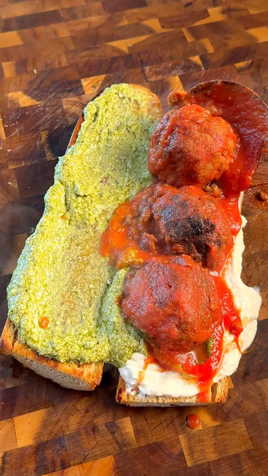 Toasted bread filled with vegan ricotta, pesto and lentil meatballs