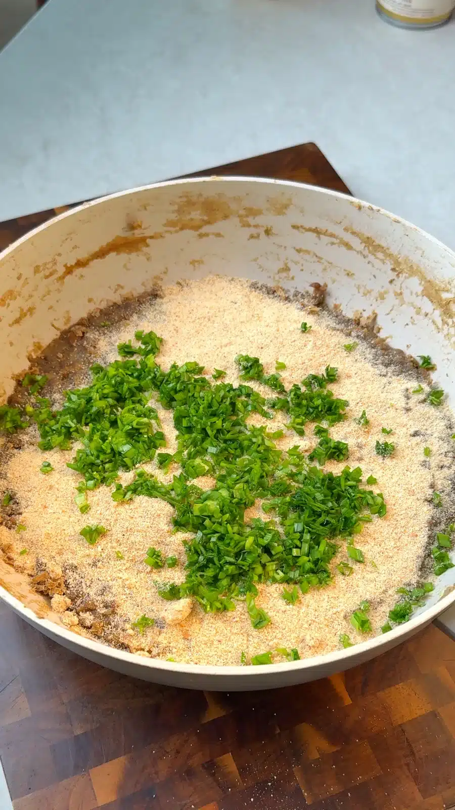Breadcrumbs and parsley added to mashed lentils and vegetables