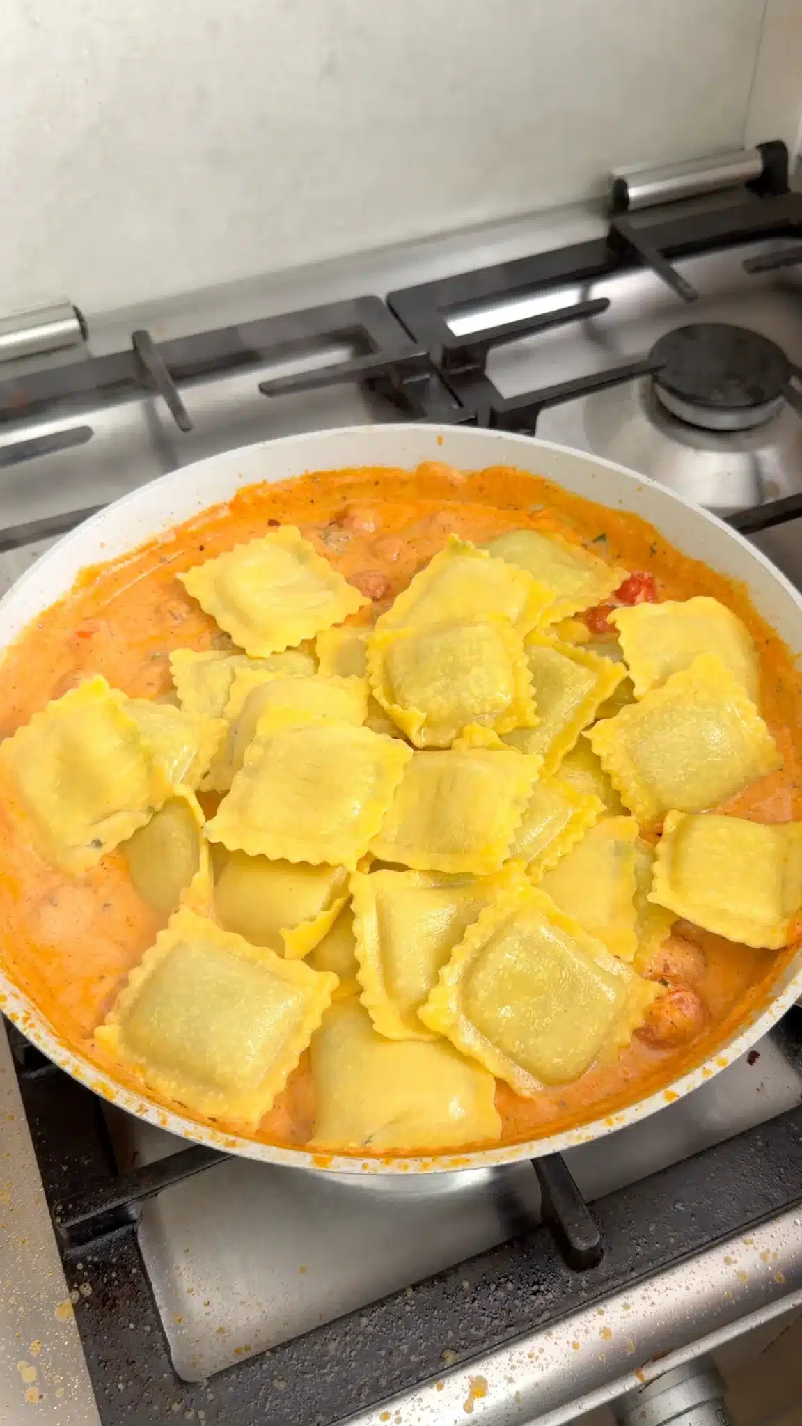 Vegan ravioli added to creamy tomatoes and spinach
