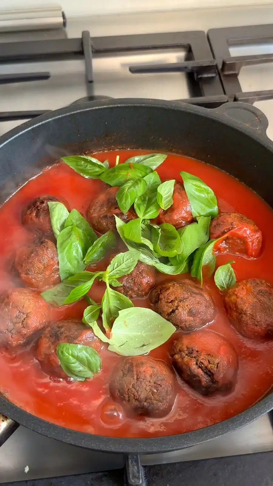 Baked lentil meatballs in marinara with fresh basil