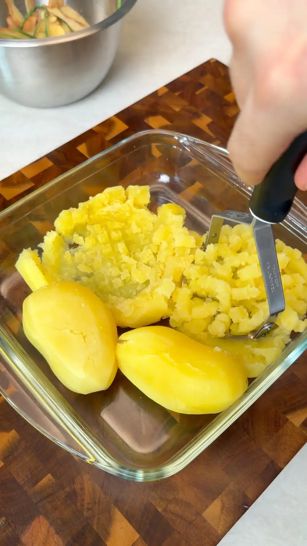 Mashing boiled potatoes for the potato flatbread dough