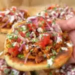 Baked potato flatbread topped with glazed tofu, tomato-onion salad, tahini yogurt and chives