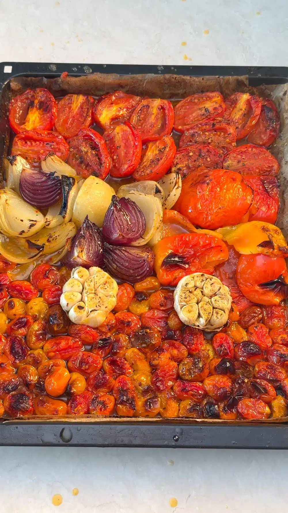 Roasted tomatoes, red peppers, onions and garlic with browned edges